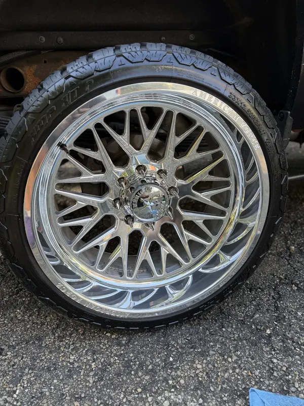 Chrome truck wheel after a Wax N' Go wheel polish — mirror finish